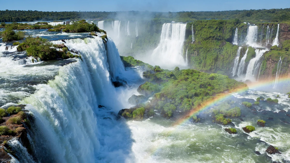 A beautiful view of Iguazu Falls with a rainbow