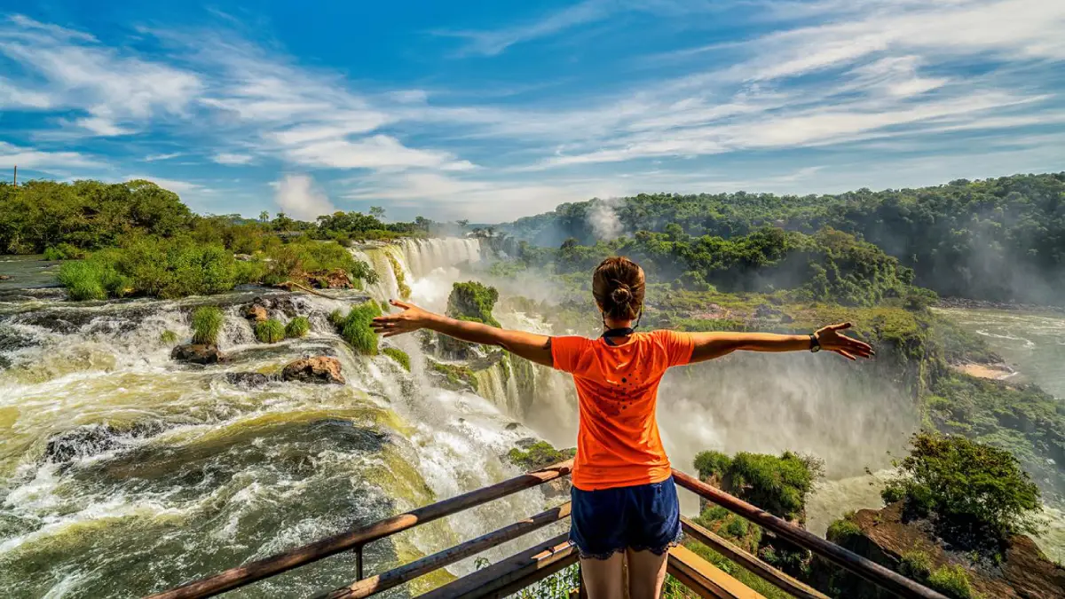 Iguazu Falls private day tour A tourist enjoying her visit to the Argentinian side of the Iguazu Falls