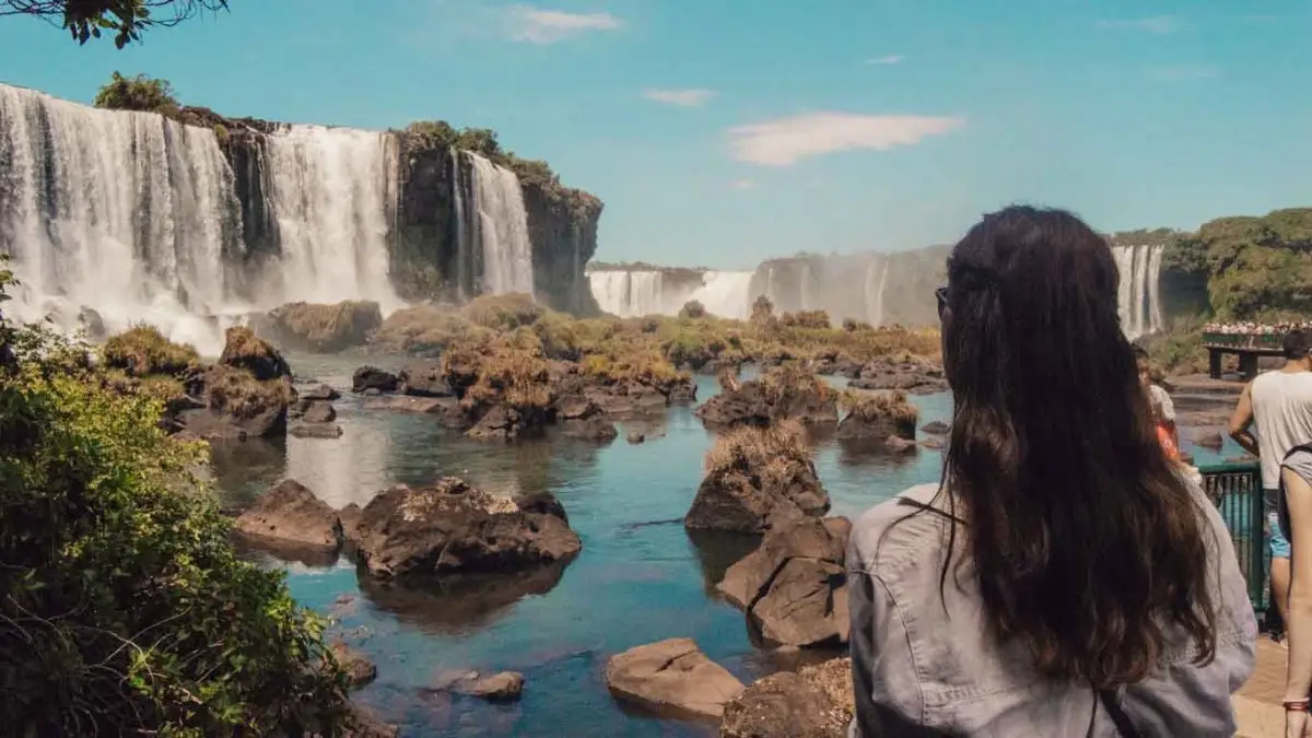 A tourist admiring the beauty of Iguazu Falls