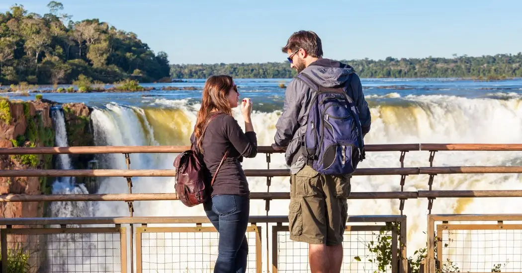 A couple exploring Iguazu Falls on a full-day tour
