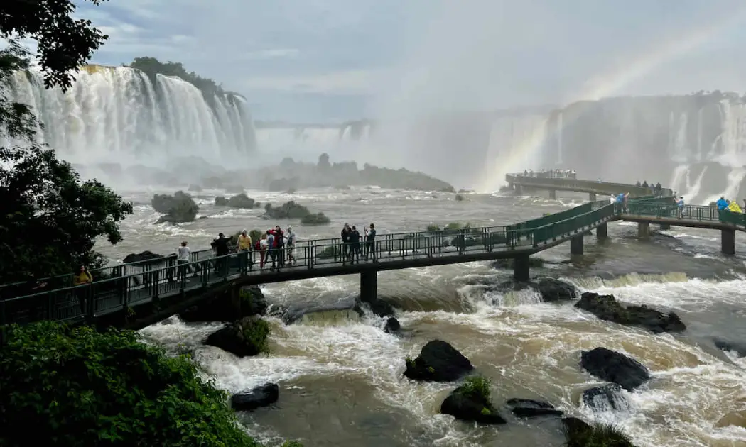 Tourists admiring the panoramic views of the Iguazu Falls on the Brazilian side