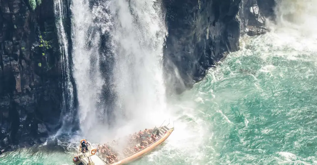 Tourists enjoying an up-close experience in the Iguazu Falls Safari boat ride